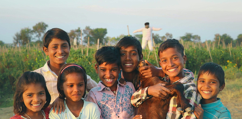 Children walking through a field on their way to school