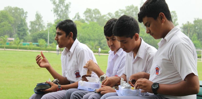 Children walking through a field on their way to school