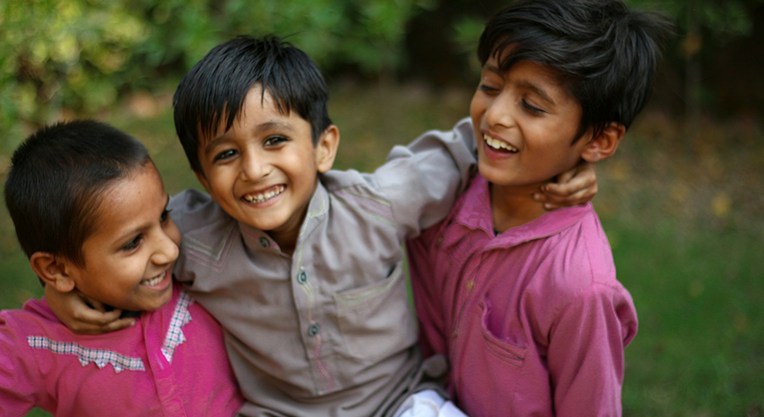 Children walking through a field on their way to school